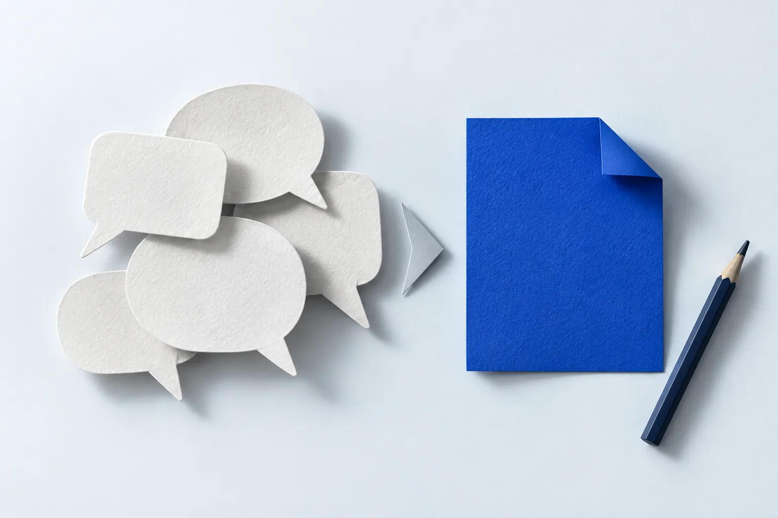 Paper conversation shapes arranged beside a single folded blue sheet